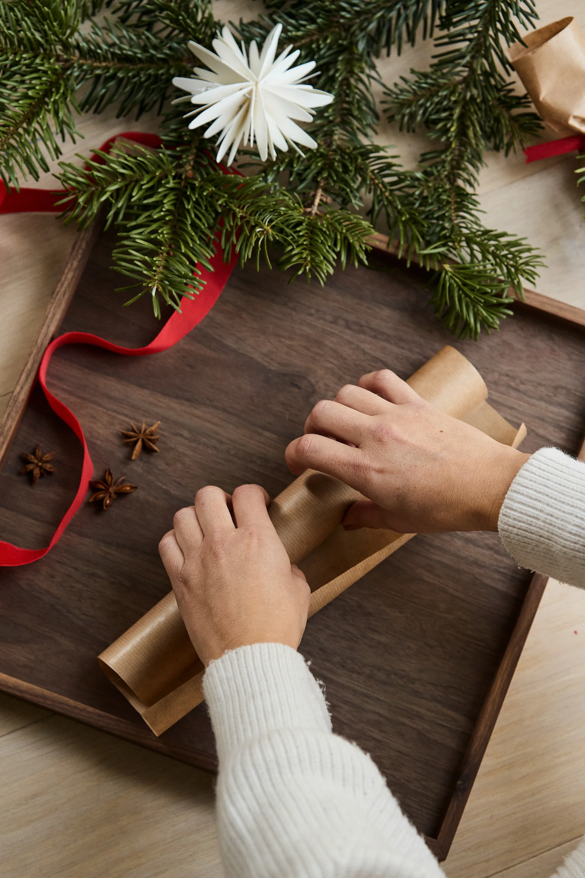 Deuxième étape de la fabrication de votre propre cracker de Noël : enroulez le papier autour du rouleau de papier hygiénique.