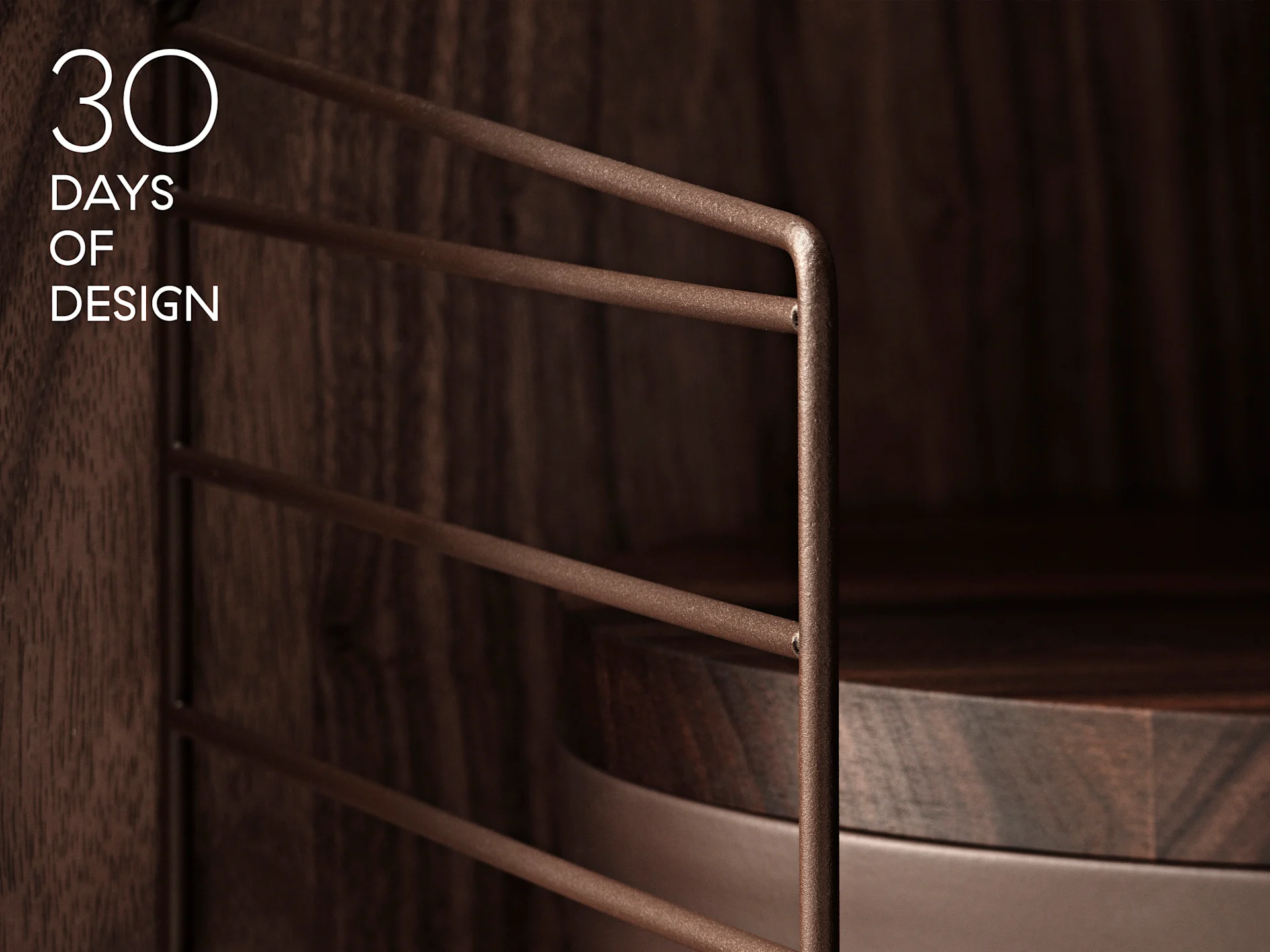 Texte '30 DAYS OF DESIGN' sur un meuble en bois foncé avec support en fil métallique brun texturé et étagère en bois circulaire.